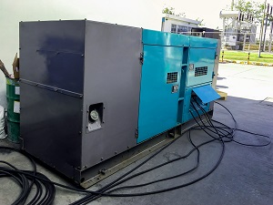 electric generator in front of a manufacturing hall