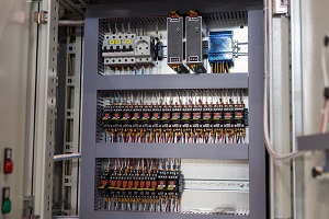 electrical lines and switches in an open control cabinet