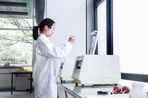 analytic instrument in a laboratory that is operated by a woman