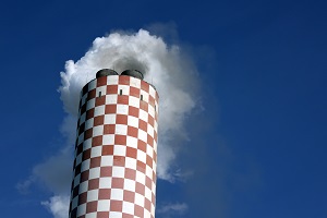 chimney of a power plant with emerging flue gas