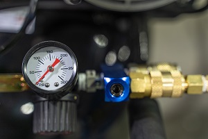 pressure gauge with black setting wheel beyond