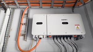 power inverter at a wall with ingoing and outgoing cables