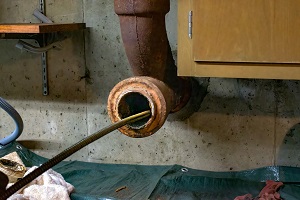 metallic spiral entering an open sewer pipe