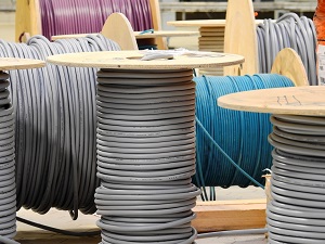 various electrical cables in grey and other colours on cable drums of different size