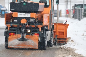 snow sweeper with strewing unit in the back